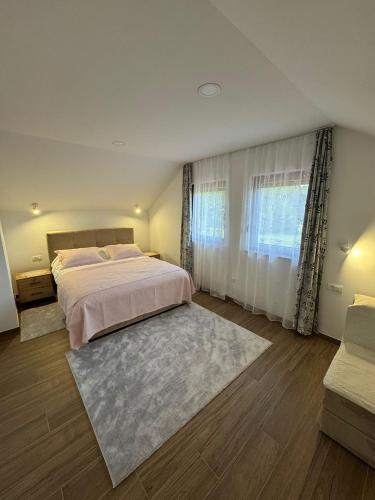 a bedroom with a large bed and a rug at Kuća za odmor Bruna in Livno