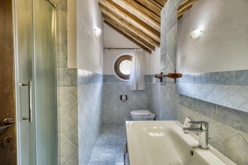 a bathroom with a sink and a toilet at Podere Montale Winery in Seggiano