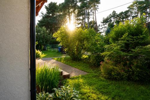 a garden view from a window of a house at Domek na Morskiej in Jantar