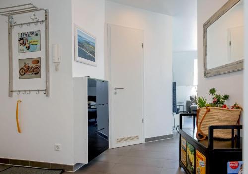 a hallway with a white door and a mirror at Ferienwohnung Rafaela in Zinnowitz