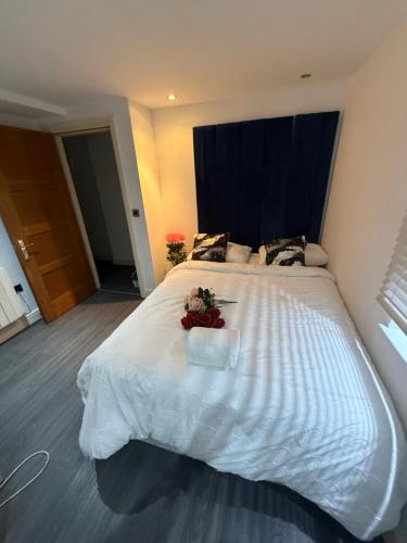 a bedroom with a large white bed with flowers on it at Echelon Executive suite 1 in Bradford