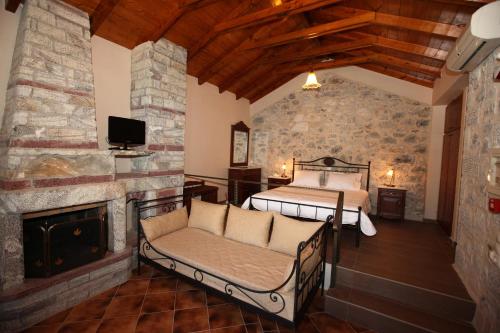 a bedroom with a bed and a fireplace at Vasilios Apartments Hotel in Limeni