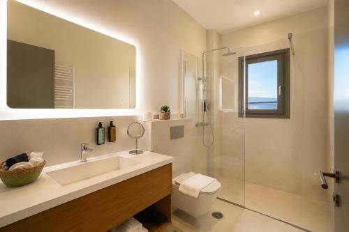 a bathroom with a sink and a shower at LEOLIA Nautical Resort Kala Nera - Handwritten Collection in Volos