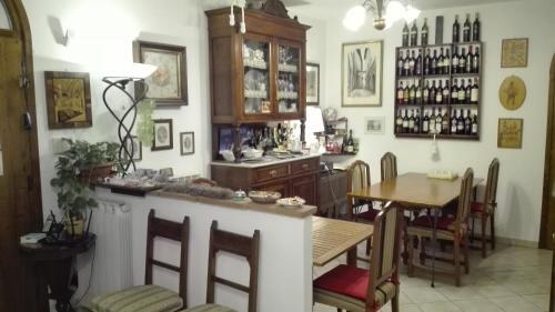 a kitchen and dining room with a bar and a table at Alfieri Bed & Breakfast in Pisa