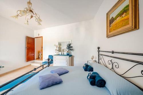 a bedroom with a bed with blue pillows on it at Gabri's Home in Spello
