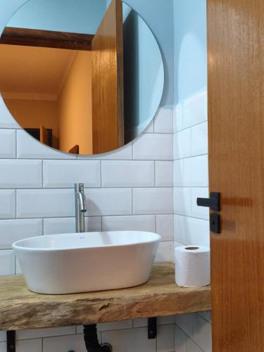 a bathroom with a sink and a mirror at Felício Reis - Pousada Colonial in Conceição do Mato Dentro