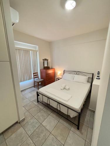 a bedroom with a bed and a chair in it at Stergios Apartment Evdilos Ikaria in Evdilos