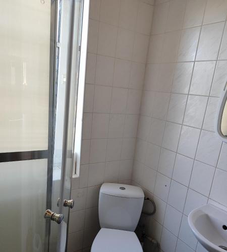 a small bathroom with a toilet and a sink at SunKiss in Melnragė
