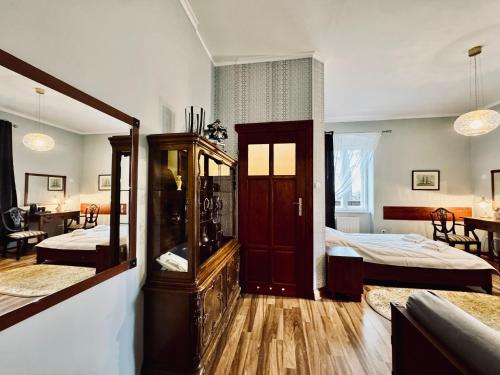 a large room with two beds and a room with a bedroom at Willa Róża Karkonoszy in Jelenia Góra