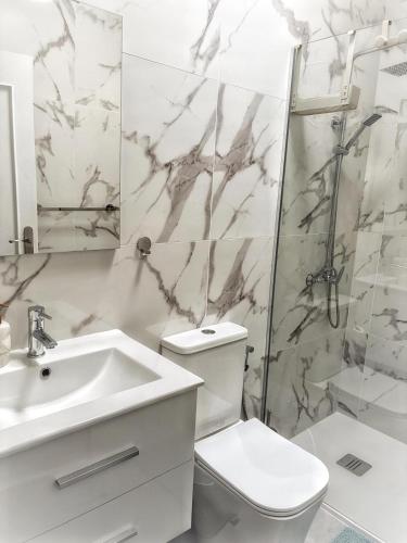 a bathroom with a sink toilet and a shower at Rentdragoana in Costa Del Silencio