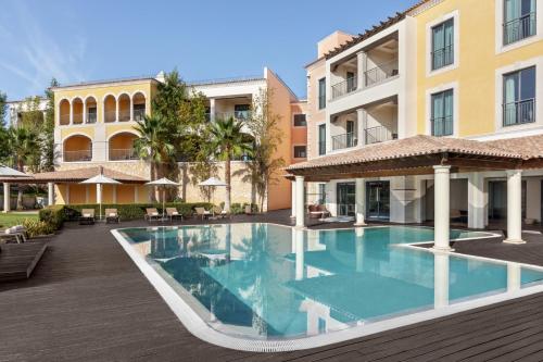 a swimming pool in front of a building at Cascade Wellness Resort Lagos Algarve by Domes in Lagos