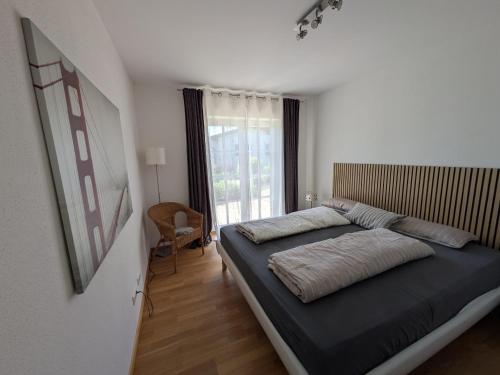 a bedroom with a bed and a large window at Golfsuite Axel in Uttlau-Haarbach in Haarbach