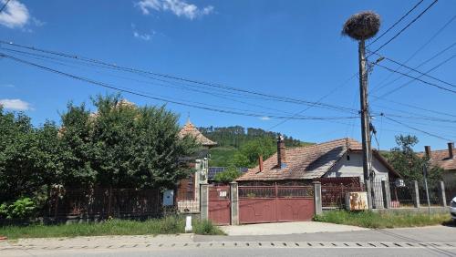 an old house with a red garage at The Nest Room in Bontida