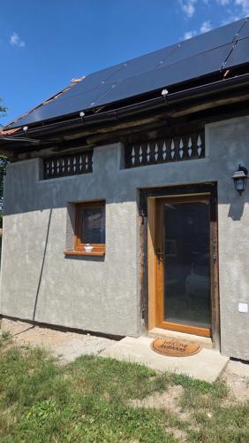 a house with a door and two windows on it at The Nest Room in Bontida