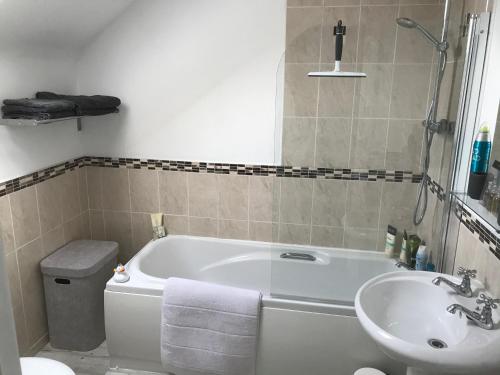 a bathroom with a white tub and a sink at The Bridge in Ballyconnell