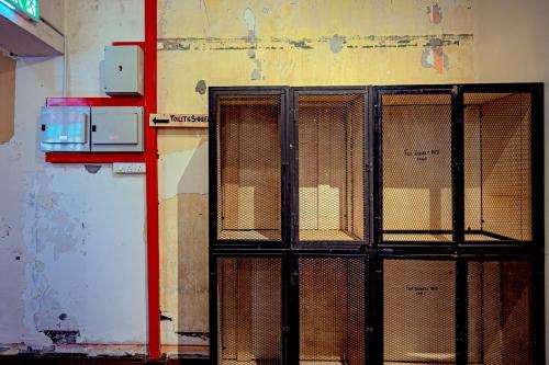 a metal gate in a room with a wall at Mingle Lekiu in Kuala Lumpur