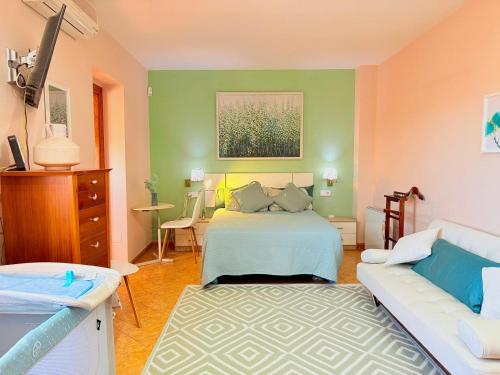 a living room with a bed and a couch at Villa Mansa in Pechina