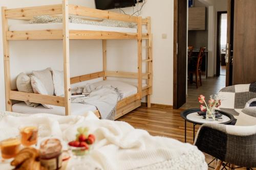 a living room with two bunk beds and a table at Villa Rustica in Bešeňová
