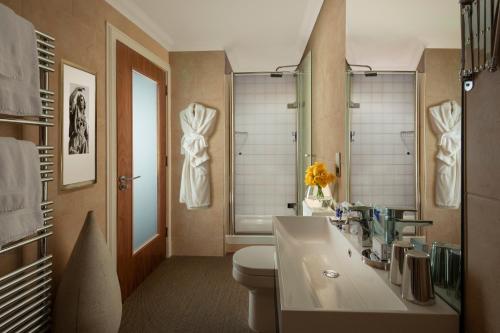 a bathroom with a toilet and a sink and a mirror at Rocpool Reserve Hotel in Inverness