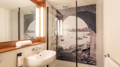 a bathroom with a sink and a shower at Campanile NATURE - Vannes in Vannes