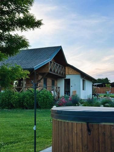 a house with a bird bath in the yard at Brzozowa Polanka II in Lipowiec Stary
