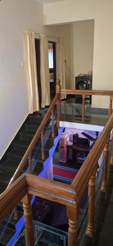 a staircase in a living room with a blue floor at Smiley Homestay in Varkala