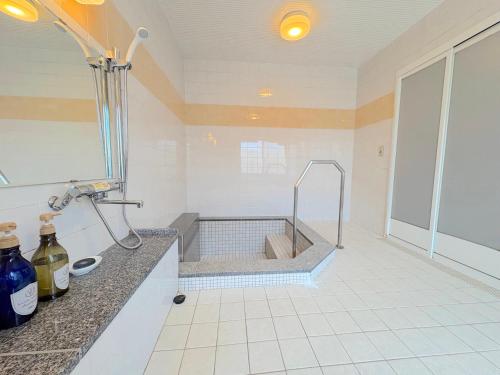 a bathroom with a sink and a bath tub at Guesthouse Yoichi in Yoichi