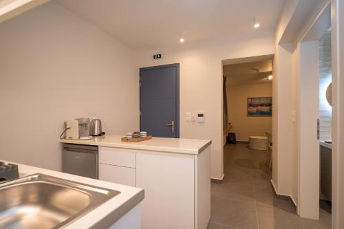 a kitchen with a sink and a counter top at Perla Port Suites in Chios