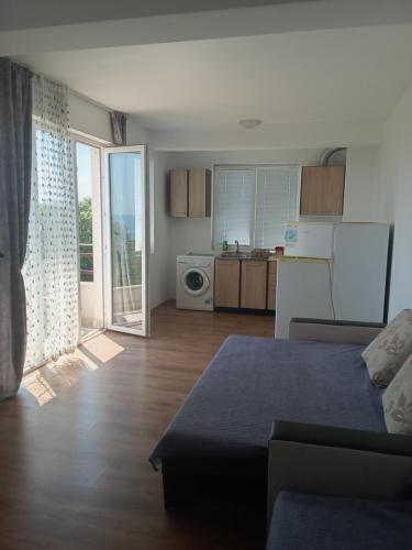 a living room with a couch and a kitchen at Апартаменты за гости Гавань in Byala