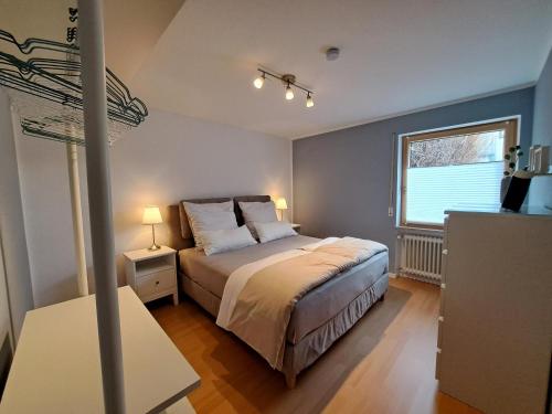 a bedroom with a large bed and a window at Freds Ferienwohnung in Kelheim