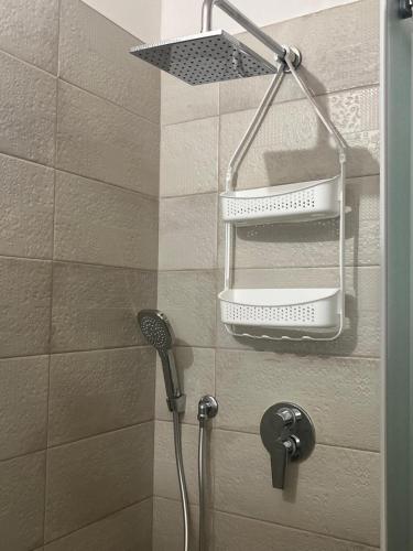 a shower with a shower head in a bathroom at La casetta di Franci in Castellana Grotte