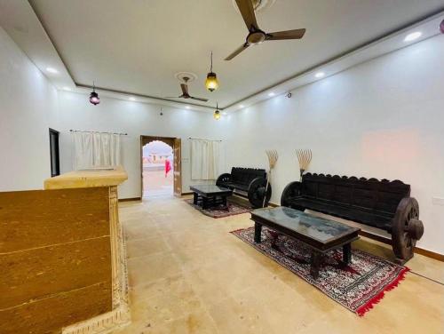 a living room with a couch and a table at Quba Desert Camp Jaisalmer in Jaisalmer