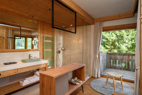 a bathroom with a sink and a shower and a sink at Vila Planinka Boutique Hotel in Zgornje Jezersko