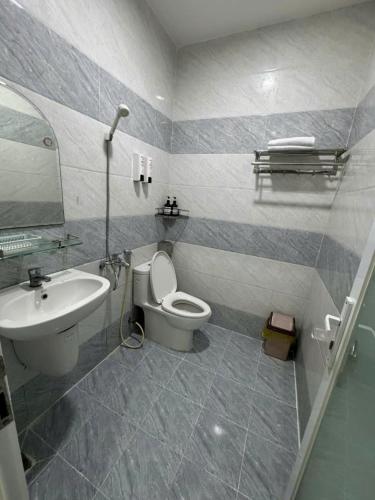 a bathroom with a toilet and a sink at Hotel Bros in Ho Chi Minh City