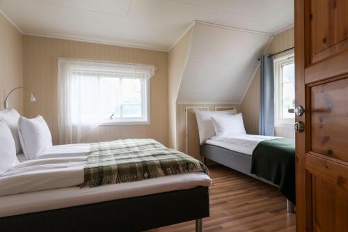 a bedroom with two beds and a window at Aurland Guesthouse in Aurland