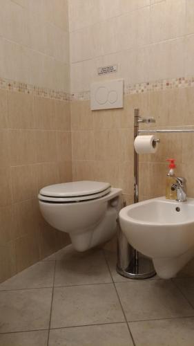 a bathroom with a toilet and a sink at Alfieri Bed & Breakfast in Pisa