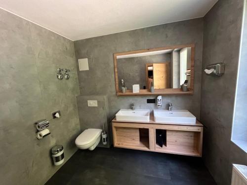 a bathroom with a sink and a toilet and a mirror at Hotel Rad in Leutkirch im Allgäu