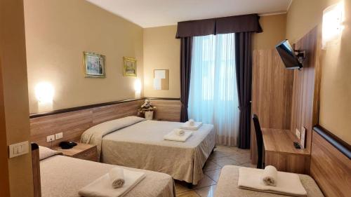 Vuode tai vuoteita majoituspaikassa Hotel Brianza