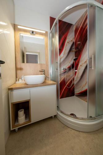 a bathroom with a sink and a mirror at Sto Rija in Krk