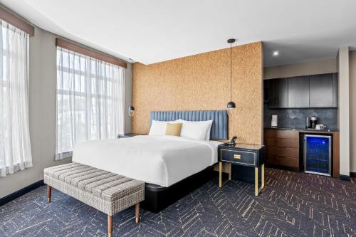 a hotel room with a large bed and a couch at Beacon Suites Hotel in Somerville