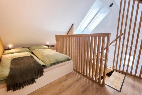 a bedroom with a bed and a stair case at Wiegehaus Retz in Retz