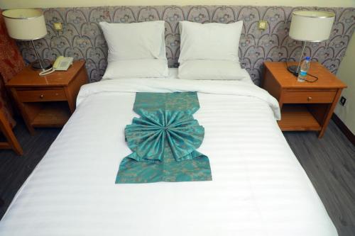 a bed with a bow tie on top of it at GHION HOTEL in Addis Ababa