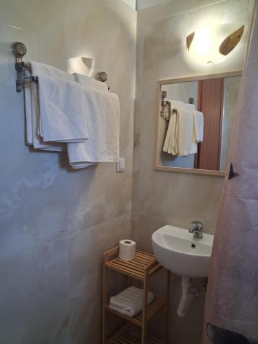 a bathroom with a sink and a mirror and towels at Villa Desire in Korinos