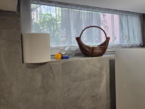 a basket sitting on a counter in a kitchen with a window at BECEJŁY de LUX in Becejły