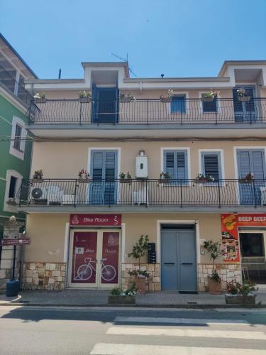 a building with windows and balconies on a street at Palazzo ReSilente- B&B dell'Infopoint in Castelnuovo Cilento