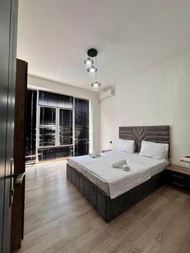 a bedroom with a large bed and a large window at Peaceful Garden Villa in Gabala