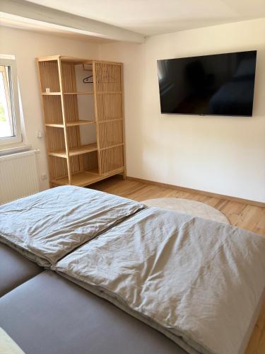 a bedroom with a bed and a flat screen tv at Modern Apartment 2 Graf - New!! in Grafenwöhr