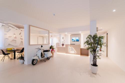 a white living room with a scooter in it at Hotel Anny in Lido di Jesolo