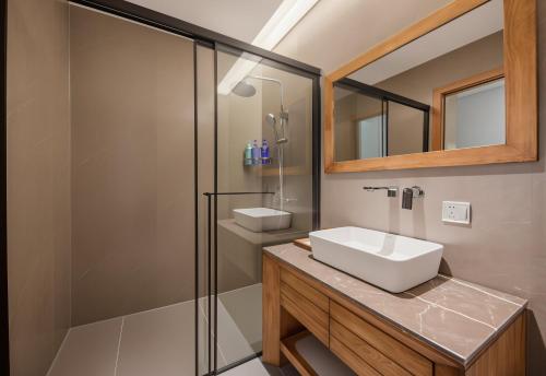 a bathroom with a sink and a shower at Zhangjiajie National Park Nvue Resort Free Laundry & Dry Service,Free Fresh coffee& Customizing Tour Plan in Zhangjiajie