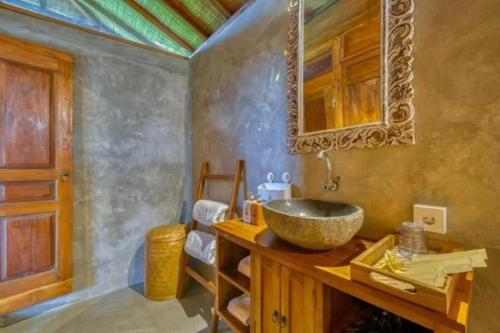 a bathroom with a sink and a mirror at Padiku Villa Semana Private Pool in Badung